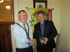 Club President Jerry Hennessy congratulates Frank O'Driscoll on winning a recent Evaluations competition.