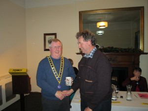 Club President Jerry Hennessy congratulates Kevin Walsh as runner-up of the pre-Christmas annual Tall Tales Contest December 2013.