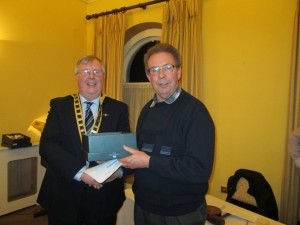 Club president Jerry Hennessy presenting David Walsh with his prize in the evaluation contest