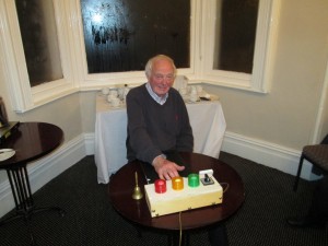  The Father of the House, our longest-serving member John Quirke, keeps an eyes on the lights and the time as Timekeeper at the Club Meeting of May 5th 2015.
