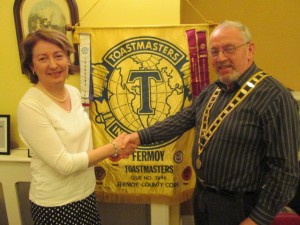         The pivotal moment when a vibrant heritage is passed on: outgoing President Mary Whelan congratulates John Sherlock on his election as President of Fermoy Toastmasters for the 2015-16 season.