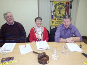  The Top Table:- Club President Eilish Ui Bhriain flanked by Toastmaster of the evening Jerry Hennessy (left|) and Topicsmaster Frank O' Driscoll with the club banner partially seen in the background. Dating from 1970 we are now within a few short years of celebrating the Golden Jubilee of our Charter in 2020. 